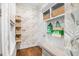 Organized mudroom with built-in storage, seating, and stylish wallpaper provides a functional and welcoming space at 2522 Daniel Island Dr, Daniel Island, SC 29492