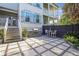 Paver patio features a built-in grill, dining set, and string lights, perfect for outdoor entertaining at 2522 Daniel Island Dr, Daniel Island, SC 29492