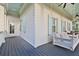 Inviting porch with swing, ceiling fan, and blue accents for relaxing outdoor living at 2522 Daniel Island Dr, Daniel Island, SC 29492