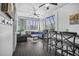 Comfortable screened porch with wood floors, white shiplap, lounge seating, bar, and black window blinds at 2522 Daniel Island Dr, Daniel Island, SC 29492