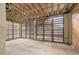 Unfinished basement with exposed beams, concrete floors, and natural light from the window wells at 2522 Waverly St, Charleston, SC 29492