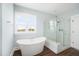 Bright bathroom featuring soaking tub and a frameless glass shower at 2522 Waverly St, Charleston, SC 29492