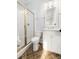 Bright bathroom featuring a shower with gold trim and a white vanity with tile flooring at 2522 Waverly St, Charleston, SC 29492