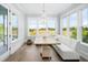 Sun-drenched breakfast nook features a banquette, modern lighting, and views of the surrounding nature at 2522 Waverly St, Charleston, SC 29492