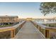 Picturesque dock extends over the water, leading to boat slips and a covered sitting area at 2522 Waverly St, Charleston, SC 29492