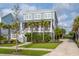 Two-story house with a metal roof, landscaped yard, and a charming porch on the main level at 2522 Waverly St, Charleston, SC 29492