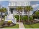 Attractive home with palm trees, manicured landscaping, and a welcoming front porch with seating at 2522 Waverly St, Charleston, SC 29492