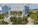 Charming two-story home featuring a metal roof, palm trees, and a welcoming front porch at 2522 Waverly St, Charleston, SC 29492