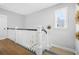 Bright hallway with white railing, wood flooring, and a sunny window at 2522 Waverly St, Charleston, SC 29492
