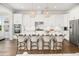 A chef's kitchen with a large island, white cabinets, stainless appliances, and modern pendant lighting at 2522 Waverly St, Charleston, SC 29492