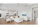 Bright living area with hardwood floors, white sectional sofa, and white kitchen in the background at 2522 Waverly St, Charleston, SC 29492