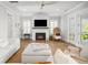 Cozy living room with a fireplace, hardwood floors, and white furniture at 2522 Waverly St, Charleston, SC 29492