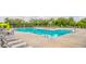 Large community swimming pool with chairs and umbrellas surrounded by a fenced in area at 2522 Waverly St, Charleston, SC 29492