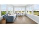 Bright sitting room with daybed, desk, and multiple windows offering panoramic views of the surrounding landscape at 2522 Waverly St, Charleston, SC 29492