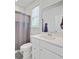 Bright bathroom featuring a shower with a curtain, a white sink and a large mirror at 2557 Hatch Dr, Johns Island, SC 29455