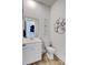 Clean and contemporary powder room with a mirror and stylish accents at 2557 Hatch Dr, Johns Island, SC 29455
