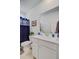 Bright bathroom featuring a white vanity, framed art, and a large mirror at 2557 Hatch Dr, Johns Island, SC 29455