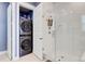 Bathroom featuring a tiled shower with a glass door and a stackable washer dryer at 2557 Hatch Dr, Johns Island, SC 29455