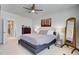 Bedroom featuring a ceiling fan, two lamps, a dresser, and a floor mirror at 2557 Hatch Dr, Johns Island, SC 29455