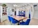 Spacious dining room featuring unique blue chairs, an intricate light fixture, and elegant decor at 2557 Hatch Dr, Johns Island, SC 29455