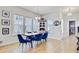 Inviting dining area with natural light, a unique light fixture, and stylish blue chairs at 2557 Hatch Dr, Johns Island, SC 29455
