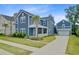 Lovely two-story home with blue siding, well-maintained yard, a porch, and detached garage at 2557 Hatch Dr, Johns Island, SC 29455
