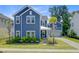 Two-story home with blue siding, manicured lawn, a cozy porch, and a convenient attached garage at 2557 Hatch Dr, Johns Island, SC 29455