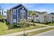 Beautiful two-story home with a charming blue exterior, complemented by lush landscaping and a sidewalk at 2557 Hatch Dr, Johns Island, SC 29455