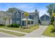 Charming two-story home boasts a stylish blue exterior, attached garage and well-manicured lawn at 2557 Hatch Dr, Johns Island, SC 29455