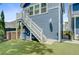 Exterior detail showing stairs and an attached structure, complemented by a manicured lawn at 2557 Hatch Dr, Johns Island, SC 29455