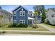 This two-story home features a blue exterior, well-kept landscaping, and a cozy front porch at 2557 Hatch Dr, Johns Island, SC 29455