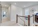 Well-lit hallway with white walls, leading to various rooms with carpet floors at 2557 Hatch Dr, Johns Island, SC 29455