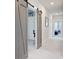 Well-lit hallway featuring modern sliding barn doors for a stylish transition at 2557 Hatch Dr, Johns Island, SC 29455
