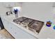 Modern stainless steel cooktop against the white tile backsplash and countertops at 2557 Hatch Dr, Johns Island, SC 29455