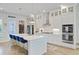 Modern kitchen with an island, stainless steel appliances, white cabinets, and stylish blue bar stools at 2557 Hatch Dr, Johns Island, SC 29455