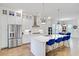 Well-lit kitchen with an island, stainless steel appliances, white cabinetry, and blue bar stools at 2557 Hatch Dr, Johns Island, SC 29455