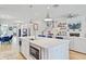 Open-concept kitchen with an island, stainless appliances, view to the stairs, and fireplace in the living area at 2557 Hatch Dr, Johns Island, SC 29455