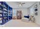 Bright living room with a large bookcase and comfortable lounge seating by the window at 2557 Hatch Dr, Johns Island, SC 29455
