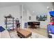 Inviting living room with hardwood floors, dining nook, and entertainment center at 2557 Hatch Dr, Johns Island, SC 29455