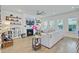Open living space with fireplace, TV, hardwood floors, and lots of natural light at 2557 Hatch Dr, Johns Island, SC 29455
