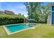 Backyard view of a pool with lounge chairs, with surrounding mature trees, offering both relaxation and privacy at 2557 Hatch Dr, Johns Island, SC 29455