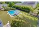 Aerial view of a backyard featuring a sparkling pool, lounge chairs, and well-manicured lawn, ideal for summer days at 2557 Hatch Dr, Johns Island, SC 29455