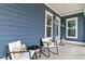 Charming front porch with comfortable chairs, ideal for relaxing and enjoying the neighborhood view at 2557 Hatch Dr, Johns Island, SC 29455