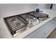 Close up of the gas stovetop with white counters and cabinets at 2557 Hatch Dr, Johns Island, SC 29455