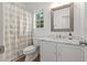 Bathroom features a marble vanity top, white cabinets, and a framed mirror at 2560 Palmetto Hall Blvd, Mount Pleasant, SC 29466