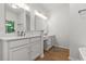 Bright bathroom with dual sinks, white cabinetry, and modern fixtures at 2560 Palmetto Hall Blvd, Mount Pleasant, SC 29466