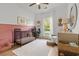 Charming Bedroom with a black crib, pink wainscoting, and a cozy reading nook at 2560 Palmetto Hall Blvd, Mount Pleasant, SC 29466