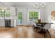 Bright dining area featuring a table with chairs, a modern chandelier, and views of the outdoor deck at 2560 Palmetto Hall Blvd, Mount Pleasant, SC 29466