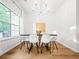 Bright dining room features white walls, wood floors, modern chandelier, and a large window with natural light at 2560 Palmetto Hall Blvd, Mount Pleasant, SC 29466