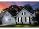Charming two-story home with inviting curb appeal, featuring manicured landscaping during a colorful sunset at 2560 Palmetto Hall Blvd, Mount Pleasant, SC 29466